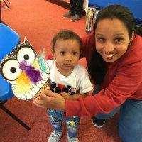 A woman and toddler with a cardboard owl