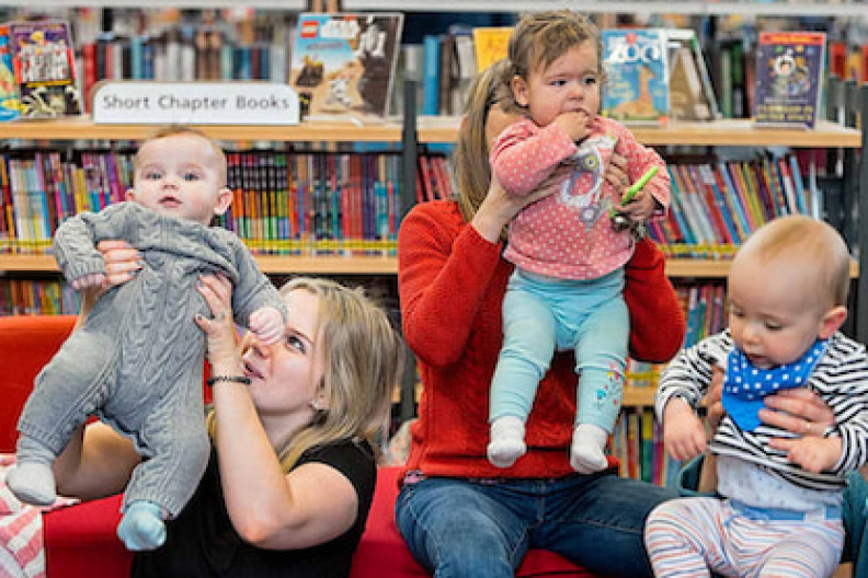 Three mums and their babies having fun at a Baby Bounce session in the library.