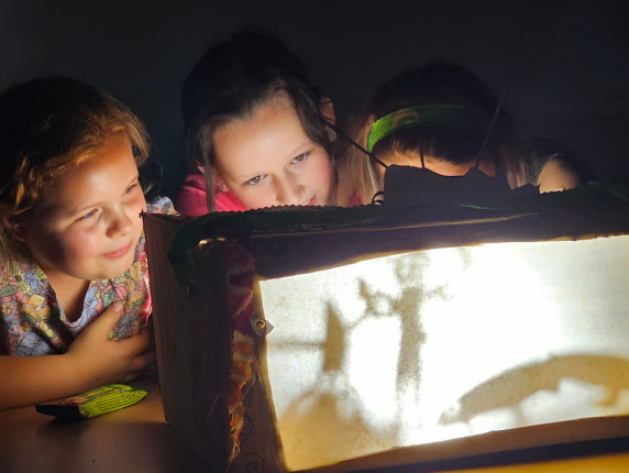 Teens experimenting with shadow puppetry
