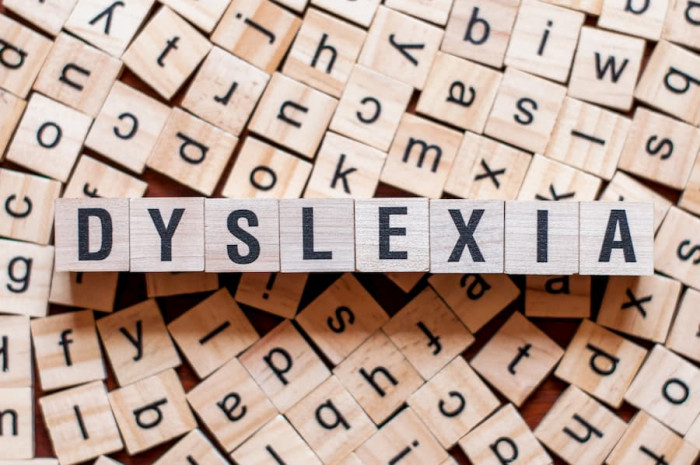 Wooden letter tiles spelling out the word 'dyslexia'