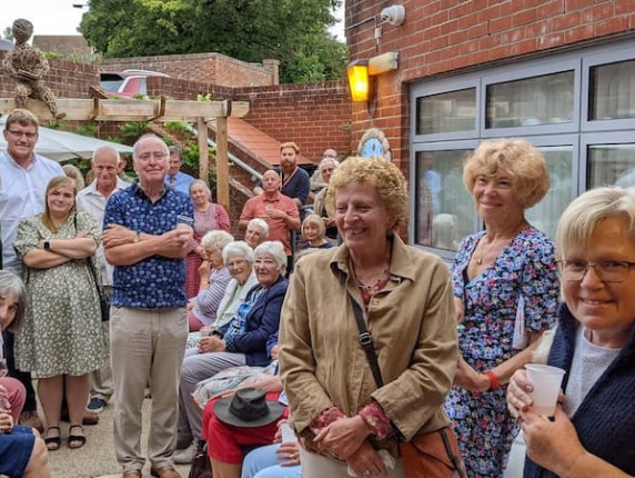 People gathered in the new Halesworth Library memorial garden with smiles on their faces.